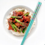 Overhead Korean pork belly with a gochujang glaze and asparagus.