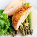 Orange marmalade chicken breast served with asparagus.