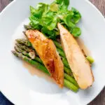 Overhead orange marmalade chicken breast served with asparagus.