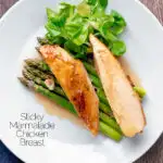 Overhead orange marmalade chicken breast served with asparagus featuring a title overlay.