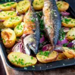 Baked whole mackerel with salad potatoes, red onions on a baking tray featuring a title overlay.