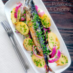 Overhead baked whole mackerel with salad potatoes, red onions and chives featuring a title overlay.