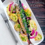 Overhead baked whole mackerel with salad potatoes, red onions and chives featuring a title overlay.