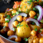 Indian chana aloo, a chickpea and potato curry served with red onion featuring a title overlay.