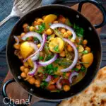 Overhead chana aloo, an Indian chickpea and potato curry served with red onion featuring a title overlay.