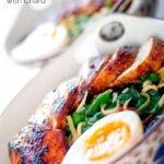Dutch angle hoisin chicken breast ramen with Swiss chard and a soft boiled egg featuring a title overlay.