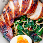 Close up overhead hoisin chicken breast ramen with Swiss chard and a soft boiled egg featuring a title overlay.