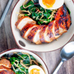 Overhead hoisin chicken breast ramen with Swiss chard and a soft boiled egg.