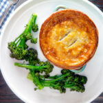 Overhead puff pastry topped individual creamy chicken and leek pie.