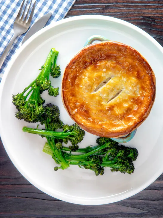 Overhead puff pastry topped individual creamy chicken and leek pie.