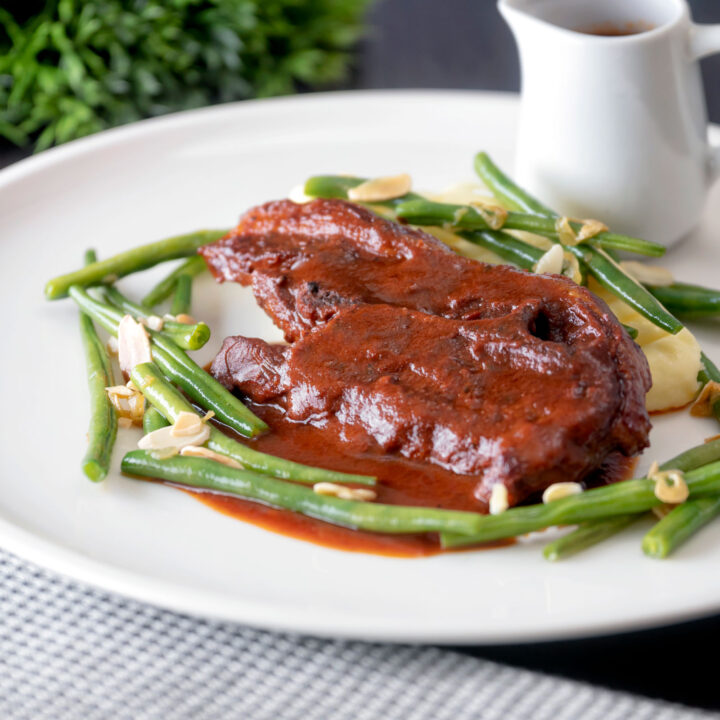 Lamb shoulder or blade chops red wine and tomato sauce with green beans amandine.