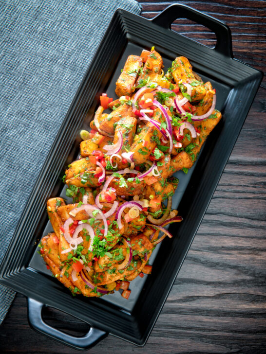 Overhead masala chips or fries topped with onion, tomato, chilli and coriander.