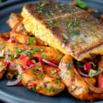 Masala fish fillet (coley) served with masala chips.