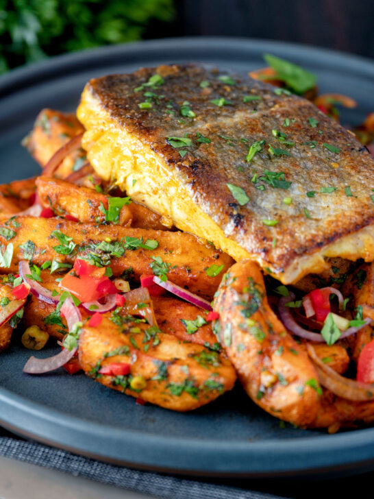 Masala fish fillet (coley) served with masala chips.