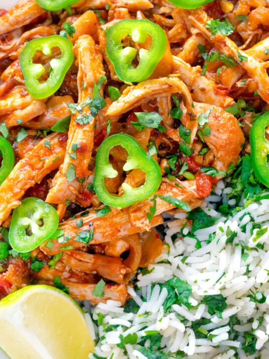 Close up overhead Mexican shredded chicken stew served with coriander rice.