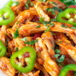 Close up Mexican shredded chicken stew served with coriander rice and jalapenos.