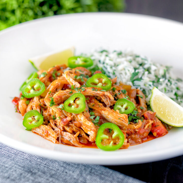 Mexican shredded chicken stew served with coriander rice, lime wedges and jalapenos.