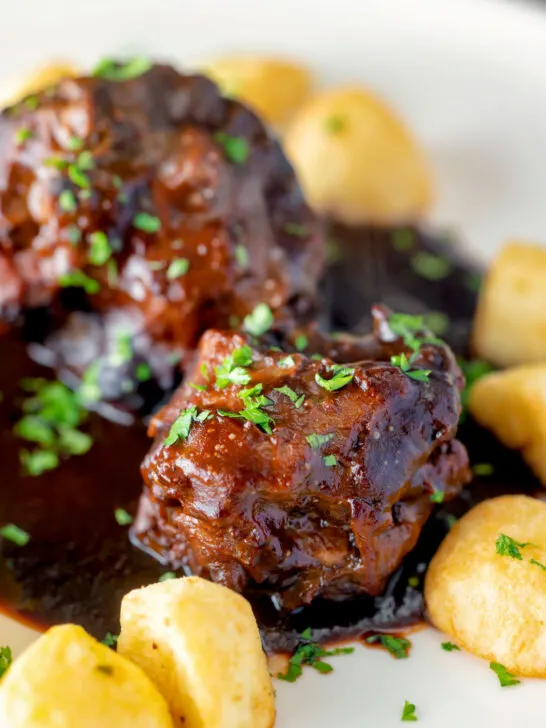 Close up rabo de toro or Spanish oxtail served with Parmentier potatoes.