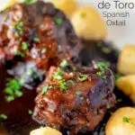 Close up rabo de toro or Spanish oxtail served with Parmentier potatoes featuring a title overlay.