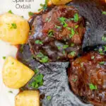 Overhead close up rabo de toro or Spanish oxtail served with Parmentier potatoes featuring a title overlay.