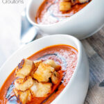 Roasted tomato soup with garlic croutons and balsamic reduction featuring a title overlay.