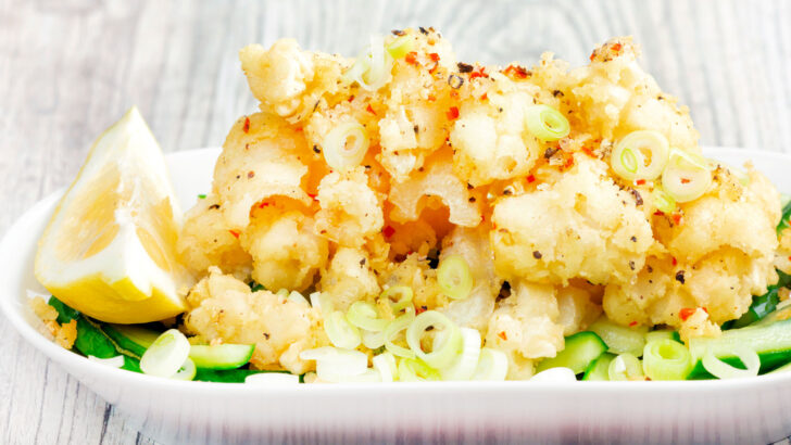 Crispy fried easy salt and pepper squid with a lemon wedge.