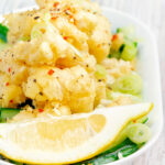 Crispy fried salt and pepper squid with a lemon wedge.