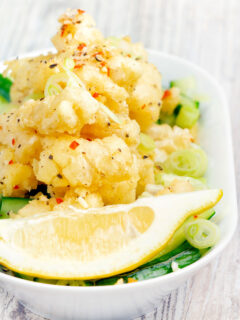 Crispy fried salt and pepper squid with a lemon wedge.