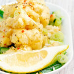 Crispy fried salt and pepper squid with a lemon wedge featuring a title overlay.