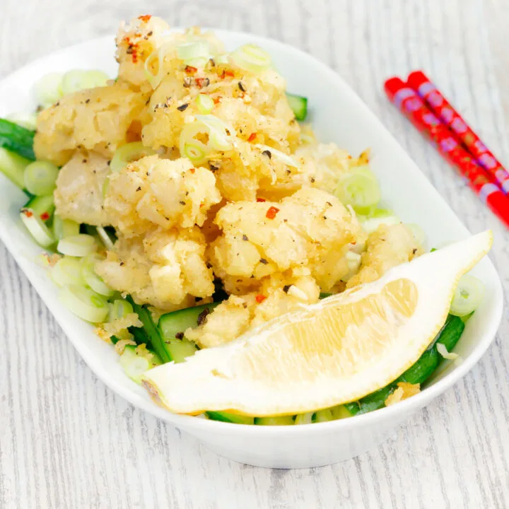 Crispy fried easy salt and pepper squid with a lemon wedge.