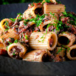 Canned sardine pasta Bolognese with rigatoni and fresh dill featuring a title overlay.