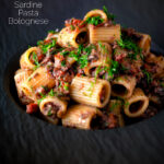 Tinned sardine pasta Bolognese with rigatoni and fresh dill featuring a title overlay.