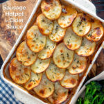 Overhead crispy scalloped potato topped sausage hotpot with cider onion gravy featuring a title overlay.