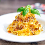 Slow cooker bolognese sauce served with tagliatelle pasta.