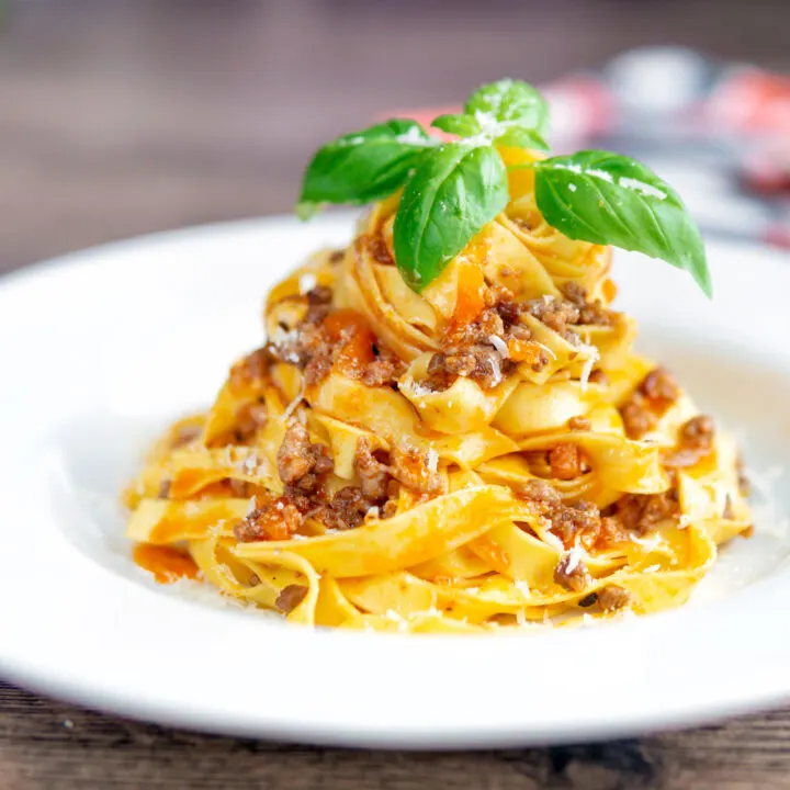 Slow cooker bolognese sauce served with tagliatelle pasta.