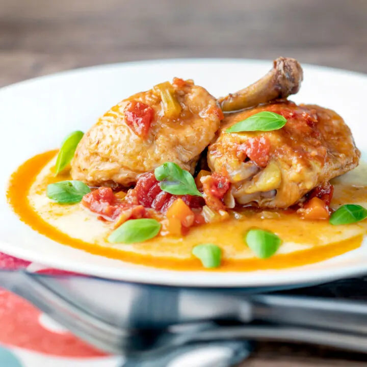 Lighter slow cooker chicken cacciatore using chicken legs served with cheesy polenta.