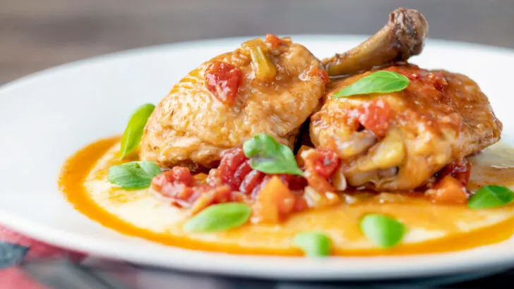 Lighter slow cooker chicken cacciatore using chicken legs served with cheesy polenta.