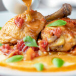 Sauce poured over a lightened slow cooker chicken cacciatore.