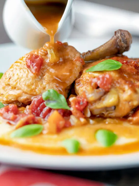 Sauce poured over a lightened slow cooker chicken cacciatore.