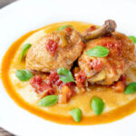 Lighter slow cooker chicken cacciatore served with cheesy polenta.