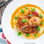 Overhead lighter slow cooker chicken cacciatore served with cheesy polenta featuring a title overlay.