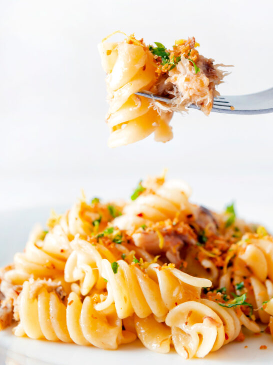 Spicy smoked mackerel pasta with chilli, lemon and golden breadcrumbs on a fork.