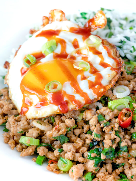 Close up of a sriracha fried egg served with Thai minced pork.