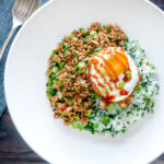 Overhead Thai minced pork with coriander rice and a fried egg.