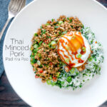 Overhead Thai minced pork with coriander rice and a fried egg featuring a title overlay.