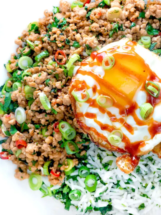 Close up Thai minced pork with coriander rice and a fried egg.