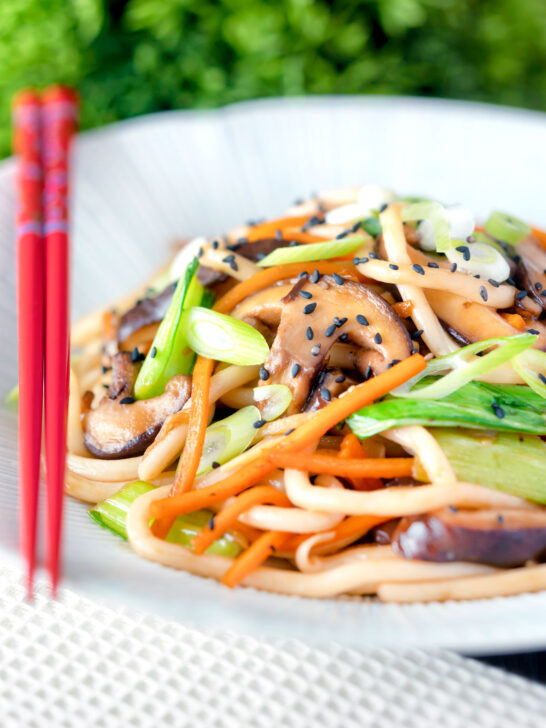 Vegan yaki udon noodles with shiitake mushrooms, carrots and pak choi.