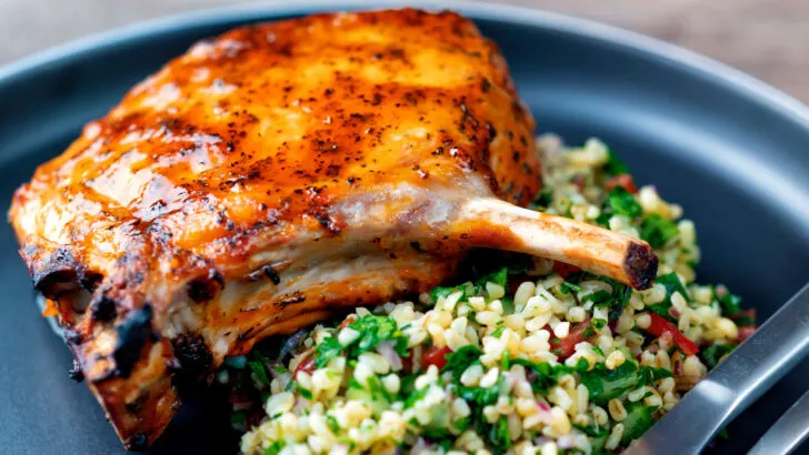 Rose harissa glazed baked pork chops with bulgur wheat salad.