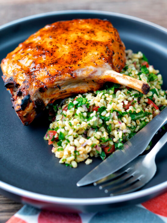 Rose harissa glazed roasted pork chops with bulgur wheat salad.