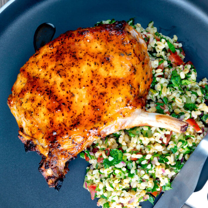 Rose harissa glazed baked pork chops with bulgur wheat salad.